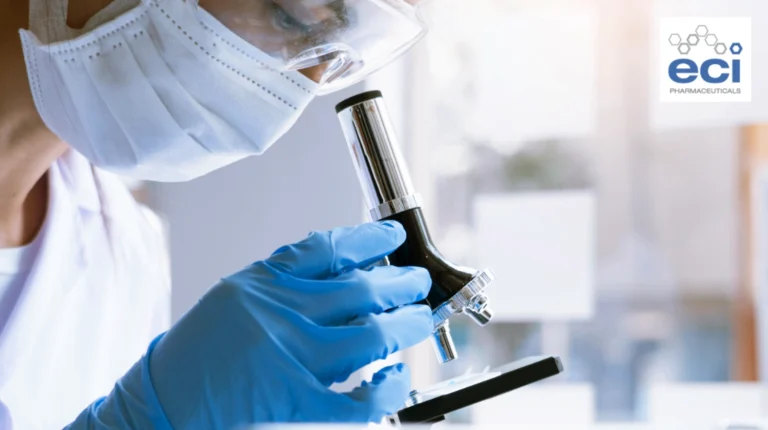 Lab scientist wearing a mask and gloves examines a sample with a microscope; ECI Pharmaceuticals logo in the corner.