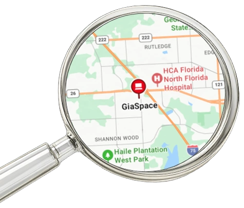 Map focusing on GiaSpace with a red pin, viewed through a magnifying glass near HCA Florida North Florida Hospital.