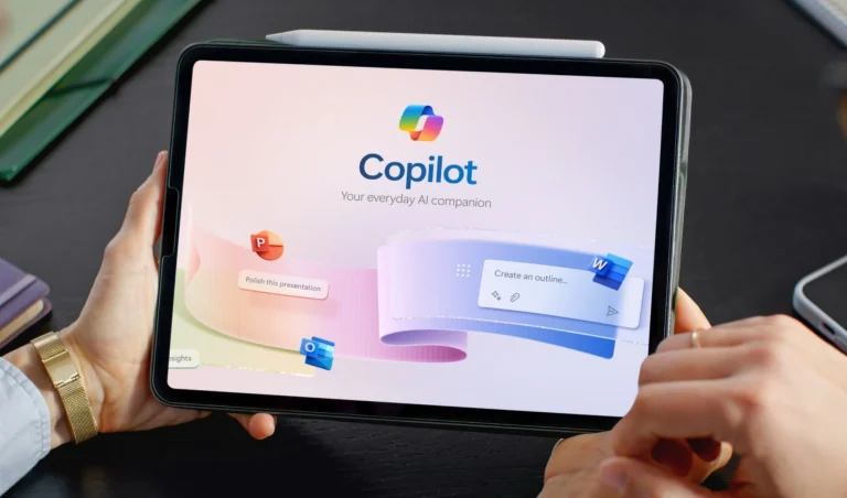 Tablet held in hands showing Copilot branding and slogan 'Your everyday AI companion' on a colorful UI backdrop.