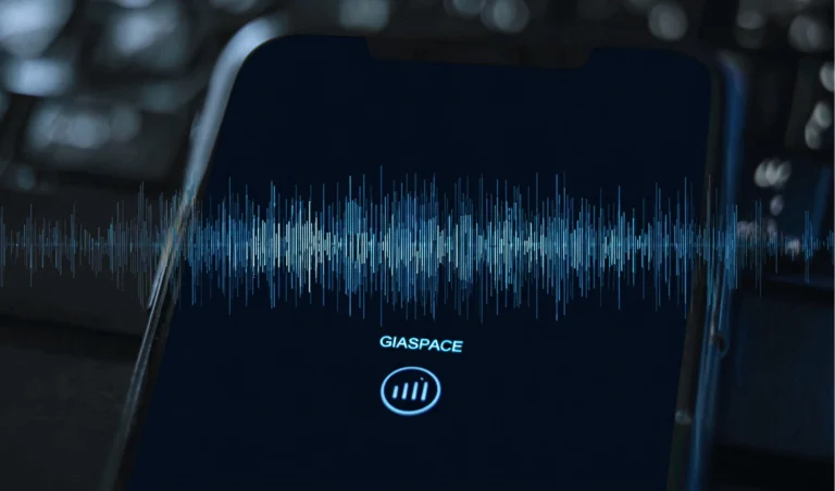 Phone screen displaying a blue audio waveform visualization on a dark background with the text 'GIASPACE' below.
